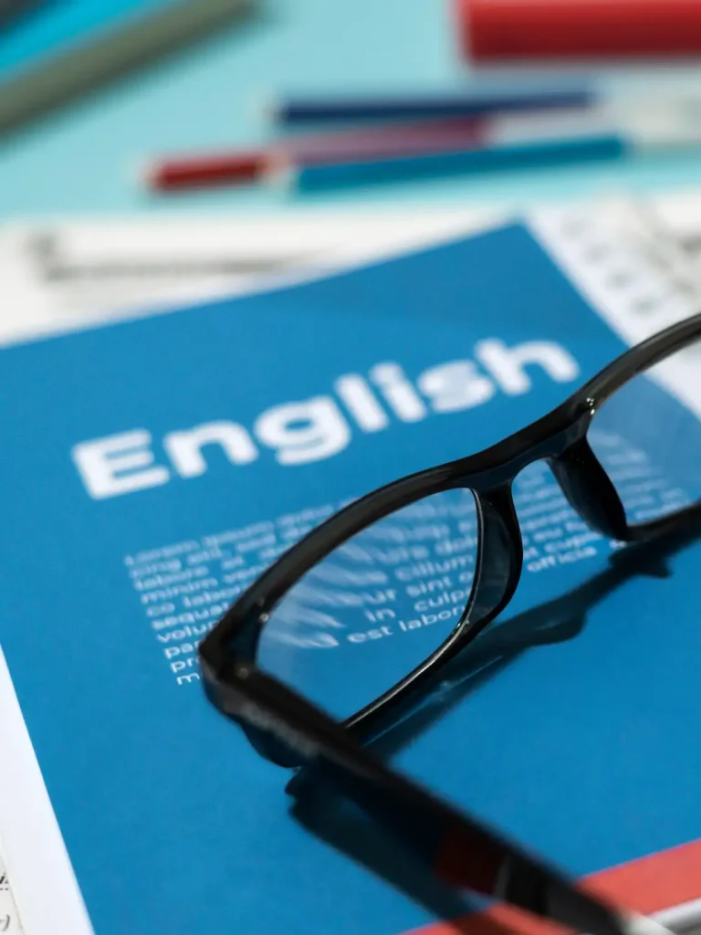 English book with glasses table